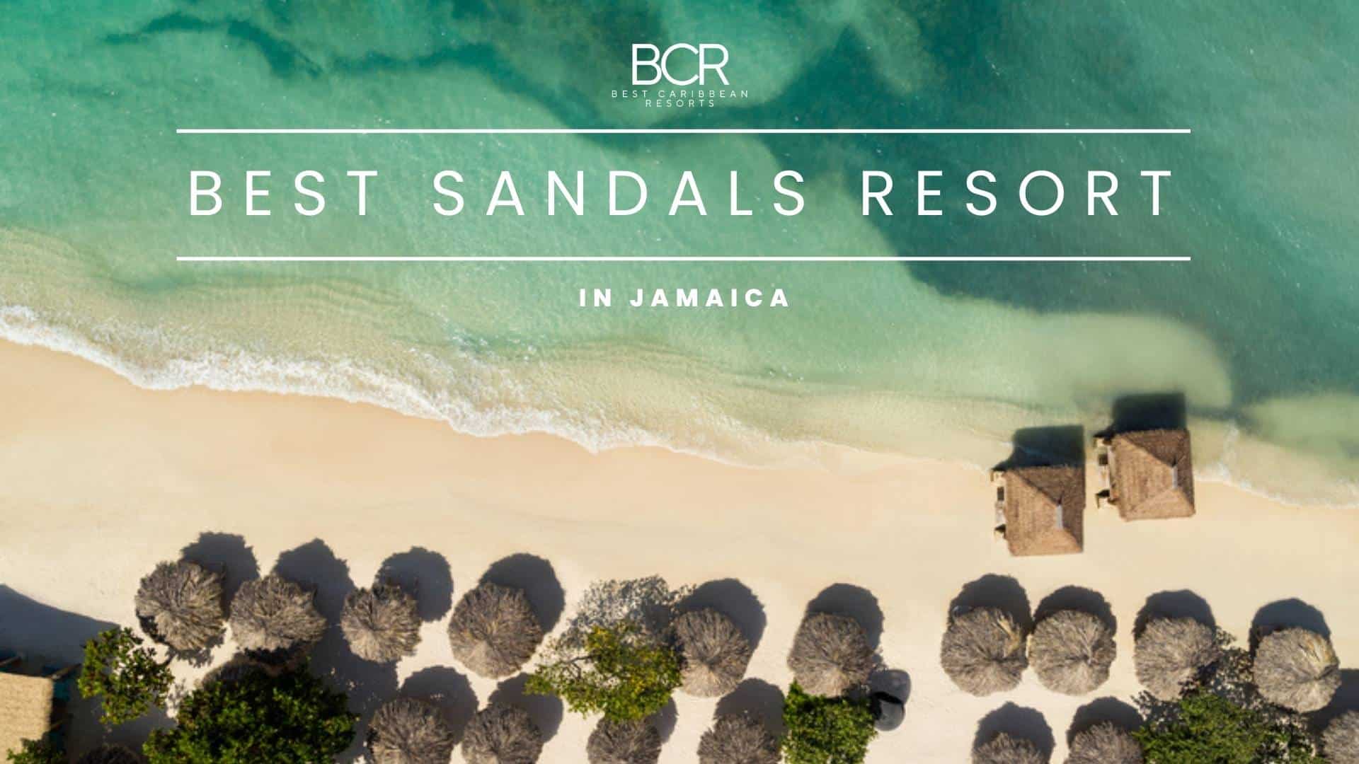 Aerial view of a sandy beach with several thatched huts and umbrellas, featuring clear blue water and gentle waves; text overlay reads 'BEST SANDALS RESORT IN JAMAICA'.