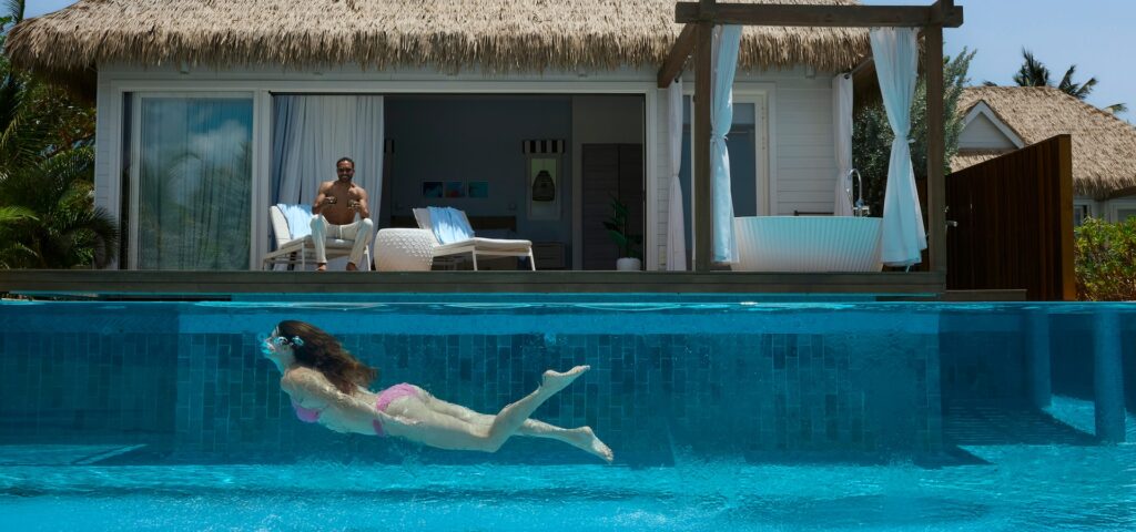 clients at Sandals Royal Curacao enjoying a swim at the pool