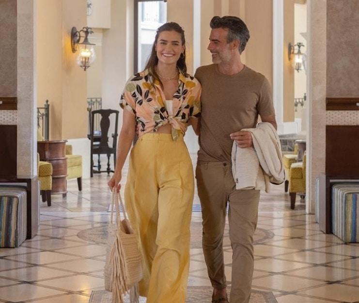 Couple walking in Sandals lobby waiting to check into Sandals Grande Antigua